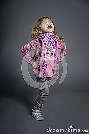 The little girl laughs very hard and smiles. Children `s laughter Stock Photo