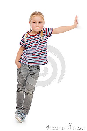 Little girl leaning against a white wall. Stock Photo