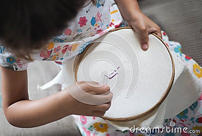 Little girl embroider needlework . Stock Photo