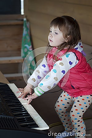 Little girl learning to play piano. Concept of music study and creative hobby Stock Photo
