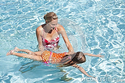 Little Girl learning to swim Stock Photo