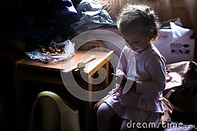 A little girl learns about the Internet through a mobile phone. Stock Photo