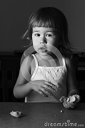 Little girl learns to make dough Stock Photo