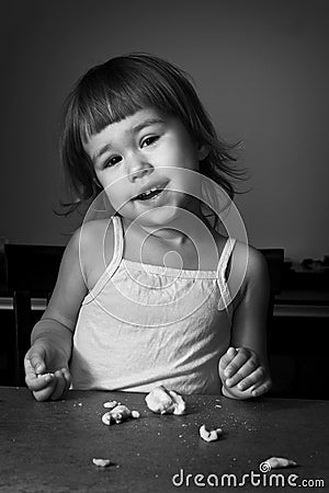 Little girl learns to make dough Stock Photo