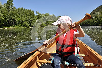 Little girl in a life jacket in a canoe Stock Photo