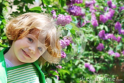 Little girl in lilac garden Stock Photo