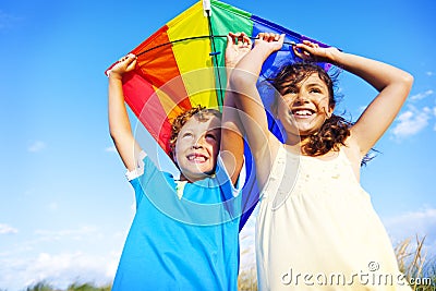 Little Girl And Little Boy Playing Kite Together Concept Stock Photo