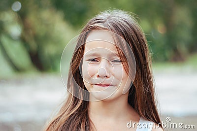 Little girl with long hair portrait, emotionally crying and upset, natural lighting outside Stock Photo