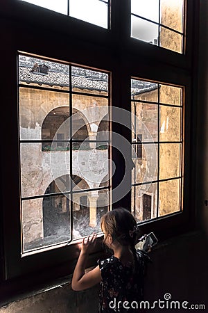 A little girl look outside to the window Editorial Stock Photo