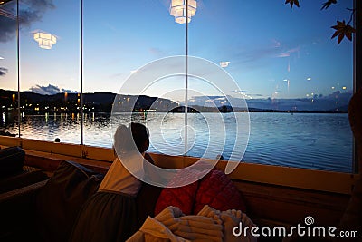 A little girl look to the eautiful view of Pamvotida lake in Ioannina Stock Photo