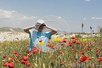 Little girl looking through binoculars outdoors Stock Photo