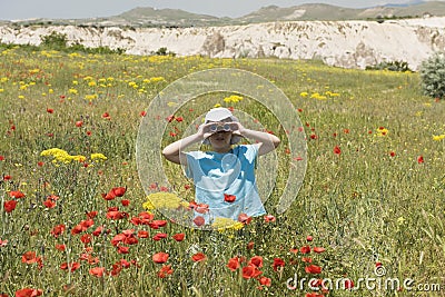 Little girl looking through binoculars outdoors Stock Photo