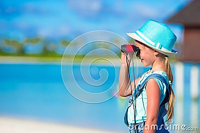 Little girl looking through binoculars in sunny Stock Photo