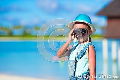 Little girl looking through binoculars in sunny Stock Photo