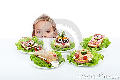 Little girl looking at creative food creatures Stock Photo