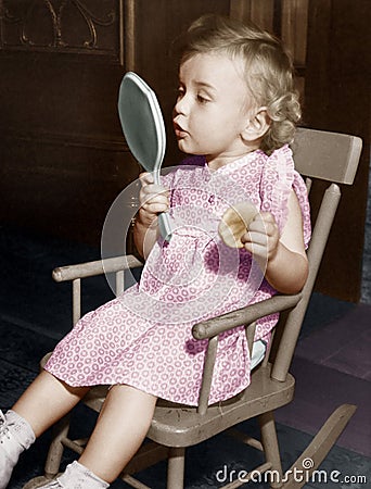 Little girl looking in mirror Stock Photo