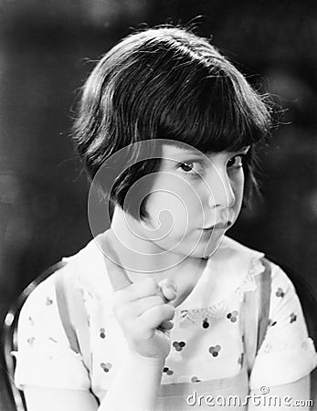 Little girl looking mischievous Stock Photo