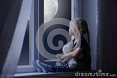 Little girl looking at the starry sky and moon Stock Photo