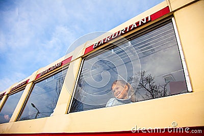 Little girl looking at window of old Georgian train Kukushka, view from outside Editorial Stock Photo