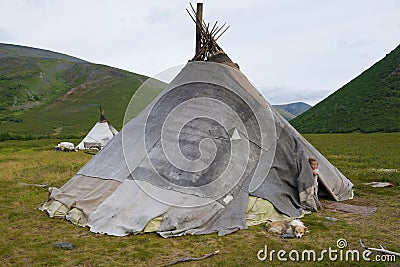 A little girl looks out of the tent on the reindeer herder camp Editorial Stock Photo