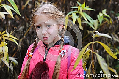 The little girl lost in the forest and has a frightened face Stock Photo