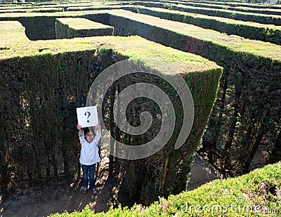 Little girl lost on a maze Stock Photo