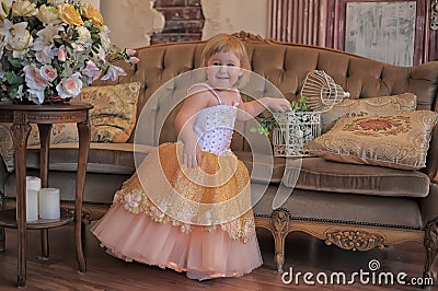 Little girl in the lush yellow with white dress Stock Photo