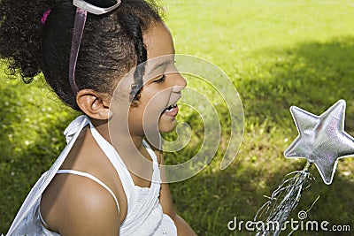 LIttle girl with magic star wand Stock Photo