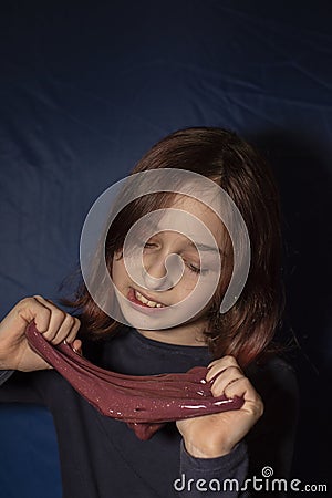 Little girl making homemade slime toy. Relax and Satisfaction Stock Photo