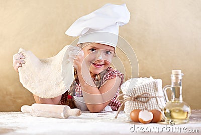 Little girl making pizza or pasta dough Stock Photo