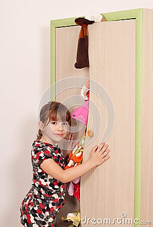 Little girl with messy closet Stock Photo