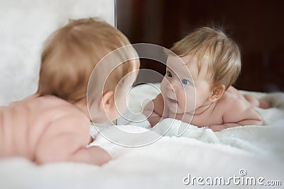 Little girl met a new friend in the mirror reflect Stock Photo