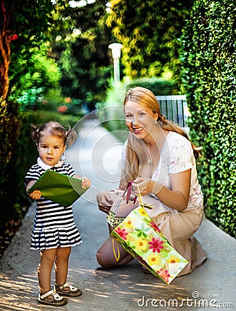 Little girl with mom holding present Stock Photo