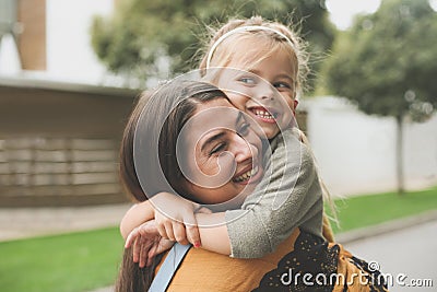Little girl in Moms hug. Stock Photo