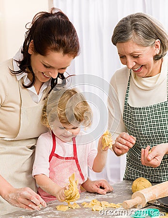 Little girl with mother cutting out cookies Stock Photo