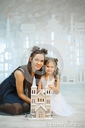 Little girl with mum plays in a fabulous white town Stock Photo