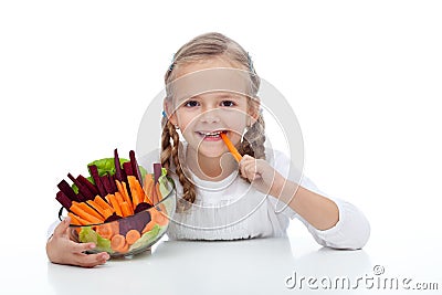 Little girl munching on a carrot stick Stock Photo