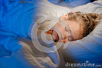 A little girl naps in bed, sees a nightmare in sleep Stock Photo