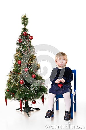 Little girl near the Christmas tree Stock Photo