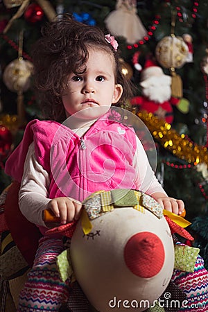 Little girl near Christmas tree waiting for Christmas Stock Photo