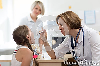 Little girl opening mouth for checkup at doctors office Stock Photo