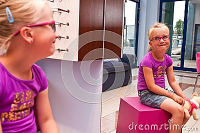 Little girl in an optician shop Editorial Stock Photo