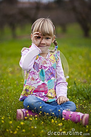 Little girl outdoors with imaginary binoculars Stock Photo