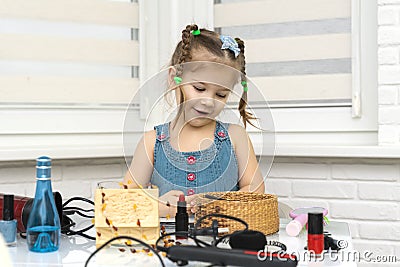Little girl is painted with mother s makeup Stock Photo