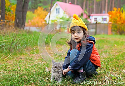 Little girl pats the cat Stock Photo