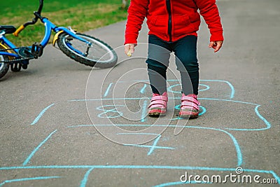 Little girl play hopscotch on playground Stock Photo