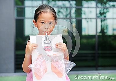 Little girl playing blowing with Simulate breathing of the lungs. Healthcare concept Stock Photo