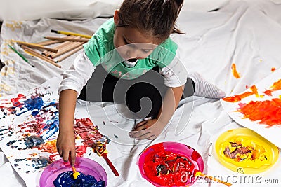 Little girl playing with color paint Stock Photo