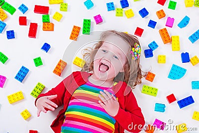 Little girl playing with colorful blocks Stock Photo