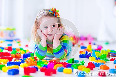 Little girl playing with colorful toy blocks Stock Photo